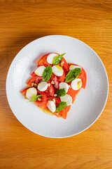 Colorful tomato slices topped with fresh mozzarella and basil make a delightful dish