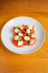 Vibrant slices of tomato paired with creamy mozzarella and fresh basil create a delightful dish