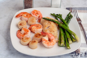 baked haddock with  asparagus  shrimp and scallops