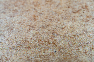 An image showcases an intricate, earthy-toned embossed texture on a fine grainy material The design could be used in various applications