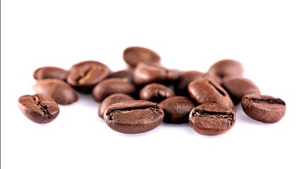 Obraz premium Close-up of scattered coffee beans on white background, showcasing rich brown color and textured surface, highlighting freshness and natural quality of roasted coffee beans for brewing.