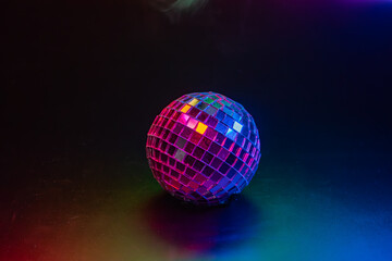 Image of a lit disco ball against a blurred background, commonly used in party or dance environments