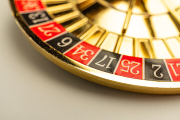 Close-up image of a luxurious roulette wheel, focusing on its alternating red and black numbered sections
