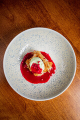 Crispy layered dessert served with vibrant raspberry sauce and refreshing mint ice cream on a plate