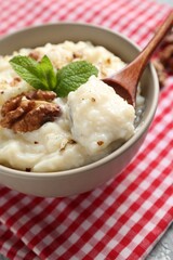 Taking delicious rice pudding at table, closeup