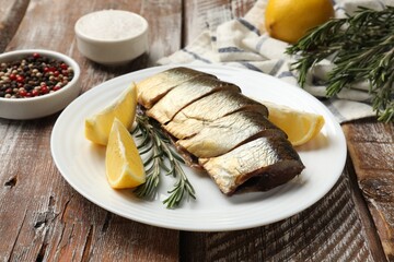 Smoked herring and spices on wooden table, closeup
