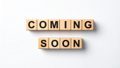 Text COMING SOON on wooden cubes on white background. Square wood blocks. Top view, flat lay.