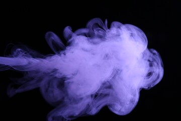 Beautiful smoke in purple light on dark background