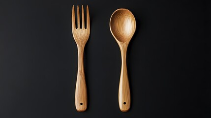 Photograph of two wooden spoons and a fork arranged on a dark background.