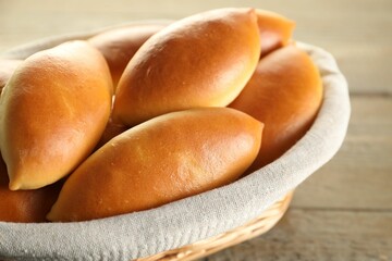 Tasty baked patties on wooden table, closeup