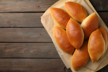Tasty baked patties on wooden table, top view. Space for text