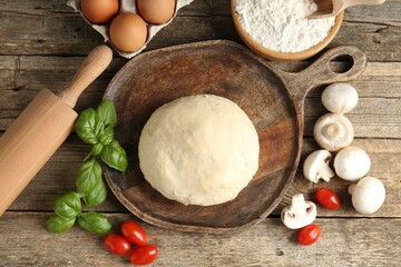 Making pizza. Different ingredients on wooden table, flat lay