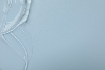 Collagen gel on light blue background, top view. Space for text