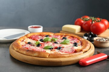 Tasty pizza and ingredients on grey table, closeup