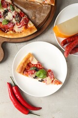 Slice of tasty pizza with thin smoked sausages served on light table, flat lay
