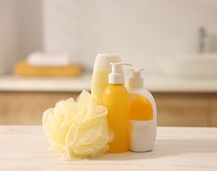 Different bathing products on white wooden table in bathroom