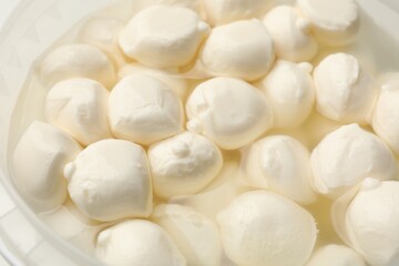 Tasty mozzarella cheese balls as background, closeup
