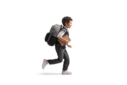 Asian schoolboy in a uniform running and holding a book