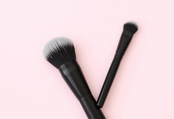 Three sleek black makeup brushes with silver-tipped bristles, arranged on a clean background,  make-up, black and silver