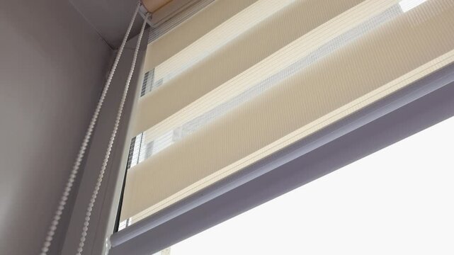 Open the blinds on the window on a sunny day, light in the room