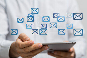 Person using tablet to manage multiple emails.  Efficient inbox management concept.