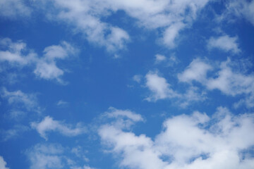 Blue sky with fluffy clouds.