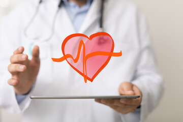 Image of a doctor holding a tablet displaying a heart with a heartbeat graphic.  Perfect for...