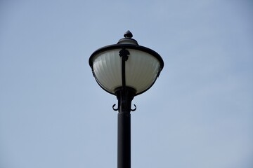 Old street lamp. Royal lamp post isolated in blue  sky background.