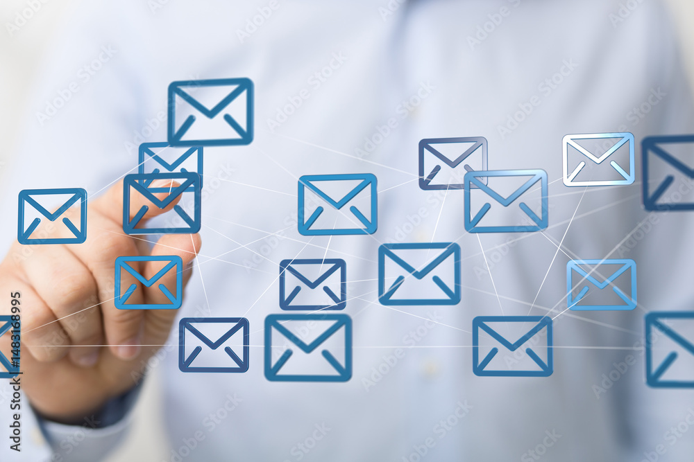Aufkleber stock photo of a hand interacting with a network of email icons, representing global communication a
