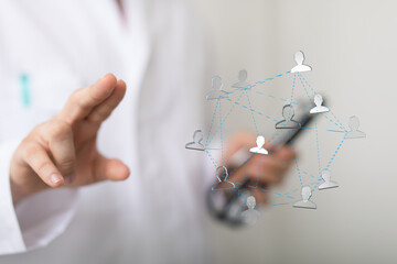 Healthcare professional using mobile technology to manage patient network.  Efficient, connected care.