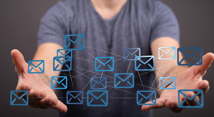Man's hands display a network of email icons, symbolizing global communication and connectivity.