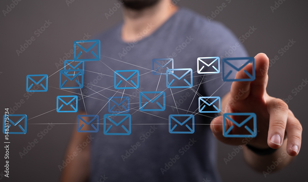 Aufkleber Man interacts with a digital network of emails, illustrating global communication and connectivity.