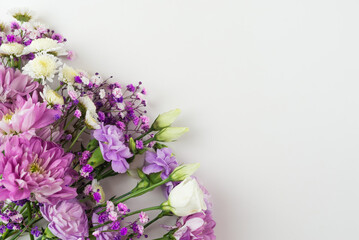 Obraz premium Creative layout of purple flowers composition on white background. Flat lay with copy space.