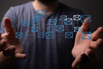 Man's hands display a network of email icons, symbolizing global communication and connectivity.