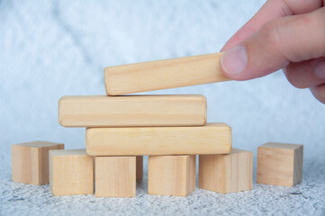 Straight view of wooden blocks with customizable space for text with hand background. Copy space concept