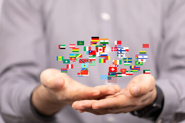 Image of hands holding a network of international flags, symbolizing global connection and...