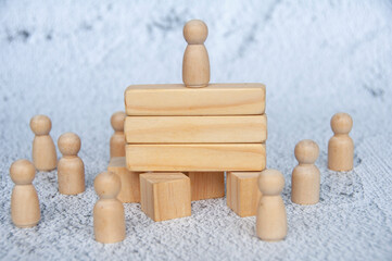 Wooden doll on to of wooden blocks with customizable space for text or ideas. Copy space and...