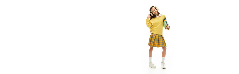 Stylish Asian schoolgirl showcasing a trendy uniform in a bright studio setting