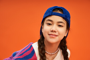 Stylish teenage girl showcases vibrant fashion in modern studio setting
