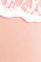 Fototapeta premium Pink sand beach with gentle waves and soft foam creating serene and tranquil atmosphere