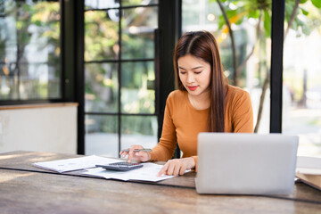 Deduction planning, debt asian young woman  hand using calculator to calculating  money balance...