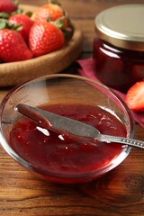 Delicious strawberry sauce and fresh berries on wooden table, closeup