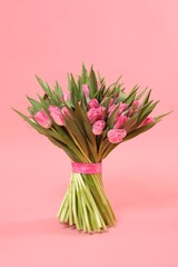 Fototapeta premium Bouquet of beautiful tulips on pink background