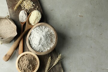 Different types of flour on light grey table, flat lay. Space for text