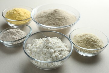 Different types of flour on white background, closeup