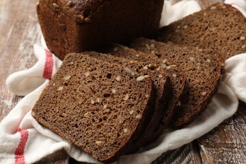 Pieces of fresh bread on wooden table, closeup