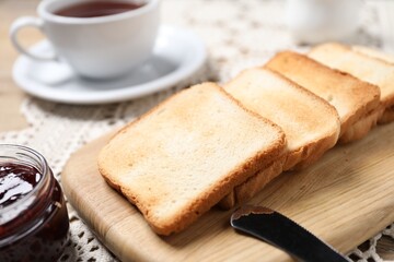Slices of tasty toasted bread and jam on table, closeup