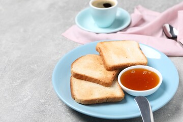 Slices of tasty toasted bread and jam on grey textured table, closeup. Space for text