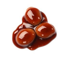 Tasty sweet candies and caramel sauce isolated on white, top view