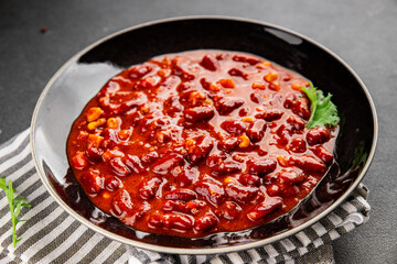 Chile con carne dish plate bean, tomato, corn, meat fresh gourmet food background on the table rustic food top view copy space